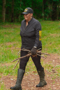 Woman carrying tree limbs