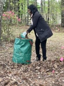 Woman disposing of leaves into bag