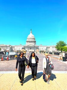 Three individuals with US Capitol building in background.